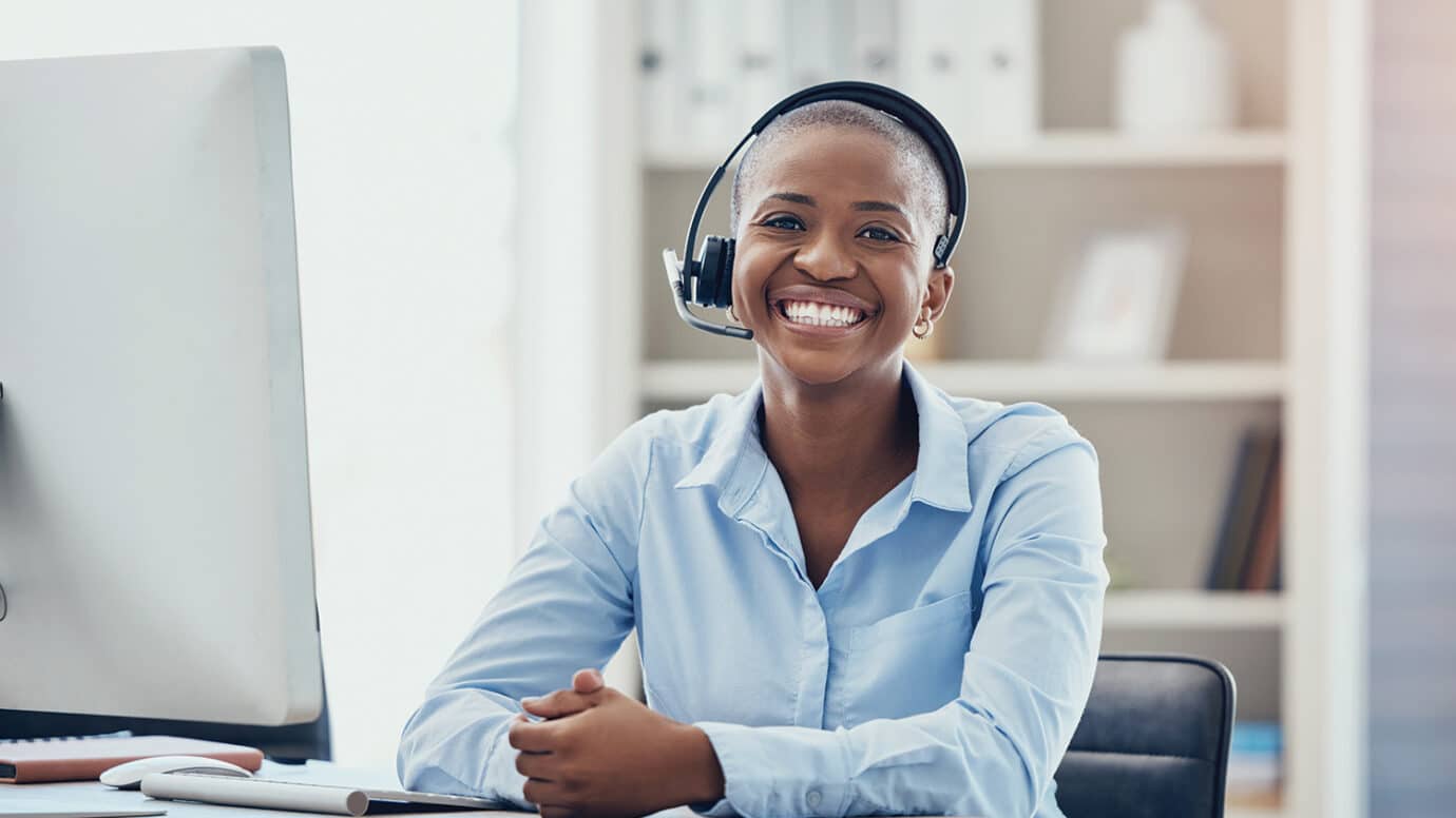 woman wearing headset at her desk