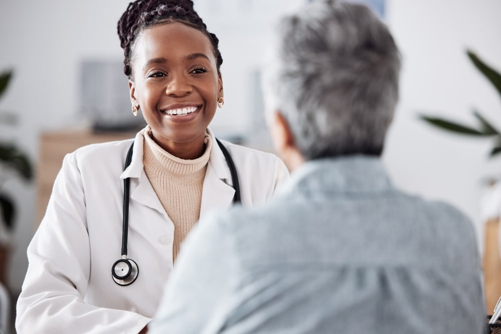 Doctor smiling and speaking with her patient