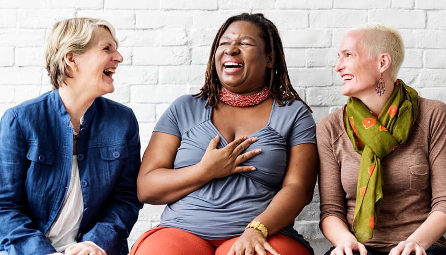 Three women laughing together